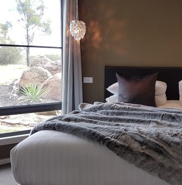 Relax in a luxurious bed with throws at Alure Stanthorpe
